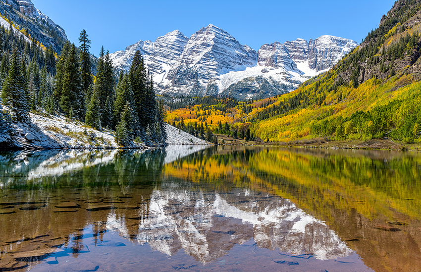 Maroon Bells in Colorado with trees and mountains in the background