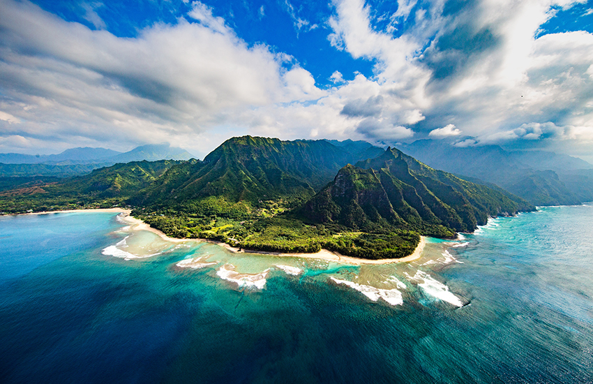Napali Coast, Hawaii with a beach and mountains in the background 