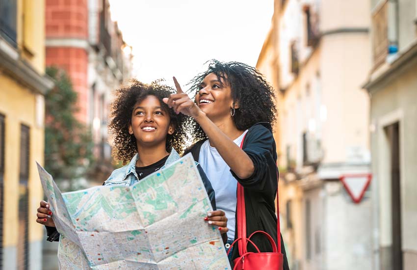 Mother and child holding a map on a city street